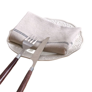 Japanese style black and white striped linen napkin with wooden handle cutlery on plate