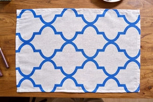 Detail of blue Moroccan trellis pattern on beige cotton linen rectangular placemat