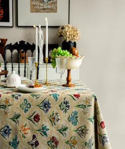 Detailed view of woven jacquard floral patterns and vintage embroidery on this tablecloth