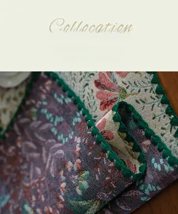 Detail of floral jacquard fabric with high-density weaving and green tassel trim