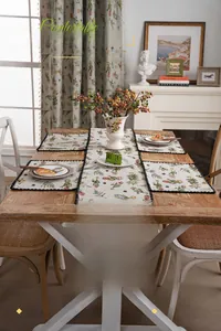 Close-up of floral embroidery detail with scalloped edges on premium table runner