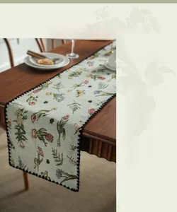 Detail of vintage floral table runner with blue embroidery and 3D butterfly patterns