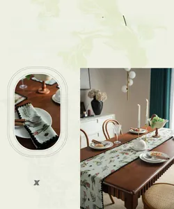 Detail of cactus embroidery and black pom-pom trim on a high-quality table runner