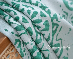 Close-up of green and white jacquard weave pattern showing soft textile texture