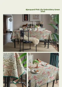 Detail of French vintage floral tablecloth with jacquard lily pattern and green scalloped edge