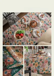 Macro detail of French vintage floral jacquard tablecloth with green scalloped embroidery