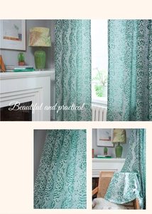 Close-up of vintage green paisley damask pattern on semi-sheer kitchen curtain fabric