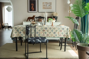 Close-up of French vintage floral jacquard tablecloth with matching leopard print chair pads
