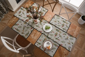 Detailed set of floral jacquard table runner and 4 placemats on wooden dining table