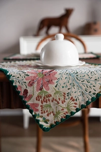 Detailed macro view of retro floral jacquard table runner with green scalloped lace edges