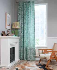 Detail view of retro green teardrop jacquard curtain with rod pocket on a living room window