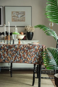 Detailed macro view of the vintage jacquard floral tablecloth with woven wavy edges