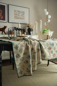 Close-up of vintage floral jacquard table runner with dark green sawtooth edge detail