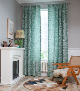 Detailed view of forest green retro curtains with jacquard pattern in a home setting