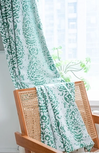 Close-up of green Paisley jacquard pattern on vintage American style cream window curtain