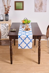 Close-up of a blue geometric pattern table runner on a dark wood dining table