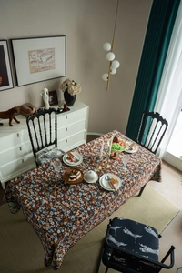 Detail of vintage floral tablecloth with intricate embroidery and colorful flower patterns