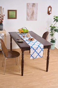 Close-up of blue geometric floral table runner on a dark wood dining table
