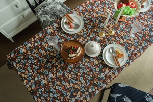 Detail shot of French vintage floral tablecloth with intricate colorful embroidery texture