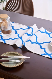 Close-up of modern blue patterned table runner on dark wood surface with cotton-linen texture
