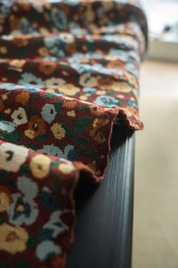 Macro detail of French vintage floral jacquard fabric with rustic woven texture
