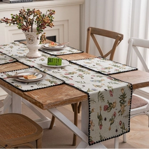 Jacquard floral table runner with placemats on wooden table in elegant rural style