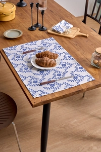 Detail of French pastoral table mat with blue floral vine print on cotton linen fabric