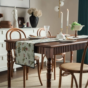 Jacquard floral table runner with sage green botanical prints and wave edges