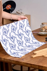 Detailed texture of French rustic style cotton linen napkin with blue floral patterns