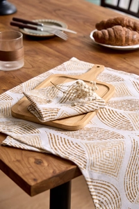 Detail view of modern wheat pattern linen napkin set on a rustic wooden dining table