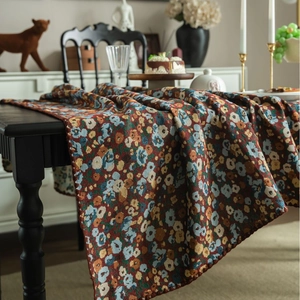 French vintage floral jacquard tablecloth with colorful embroidery on dark wood dining table