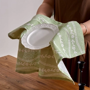 Modern minimalist green napkin with white floral print made of cotton linen for table decor