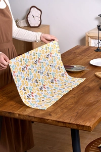 Detail view of yellow floral cotton linen napkin used as a rustic photography prop