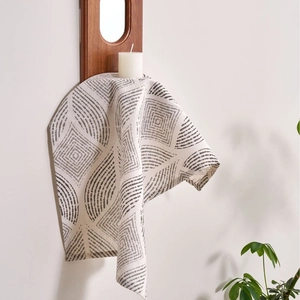 Modern grey geometric pattern cotton linen napkin hanging on a wooden wall candle holder