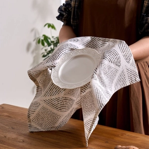 Minimalist grey geometric print linen napkin used as an elegant table setting mat