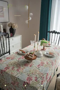 Detail of French vintage floral tablecloth with intricate shell-shaped embroidered edges