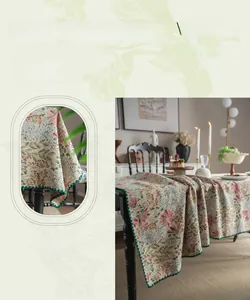 Detailed close-up of French vintage yarn-dyed pink lily embroidery and green scalloped edge