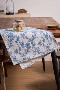 Detailed view of blue floral print on cotton linen table runner with vintage style