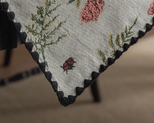 Close-up of French vintage tablecloth with fern patterns and scalloped crochet lace edge