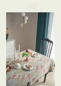 Detail of French vintage floral jacquard tablecloth in a cozy dining room setting