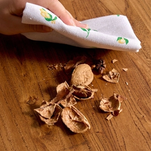 Linen fabric napkin with lemon print on a wooden table for home kitchen decor