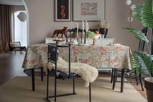 Detailed close-up of a French retro floral tablecloth with scalloped green edges