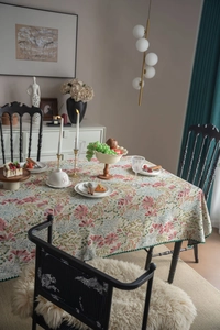 Detail of French vintage floral tablecloth with intricate embroidery and green lace edges