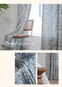 Detail of grey vintage jacquard curtain fabric showing damask pattern and drape texture