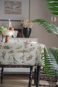Detailed close-up of French vintage jacquard tablecloth with floral embroidery and wavy edges