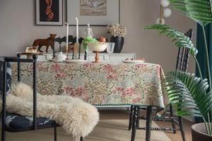 Detail of French retro floral jacquard tablecloth with elegant green stitched border