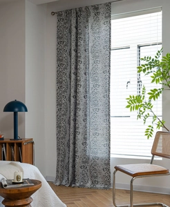 Detailed view of grey damask jacquard curtain fabric texture and rod pocket hanging style