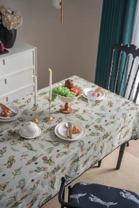 Detailed view of French vintage floral tablecloth with black fringe and nature patterns