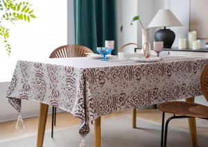 Detail of Nordic grey tassel tablecloth with vintage damascus pattern and fringe balls