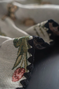 Detailed macro view showing French vintage jacquard embroidery and scalloped edge finish